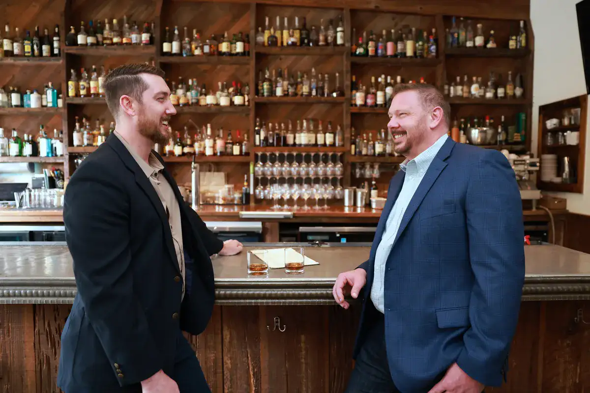 John Paul and Michael Cavanaugh of Manucci Financial in a Houston restaurant.